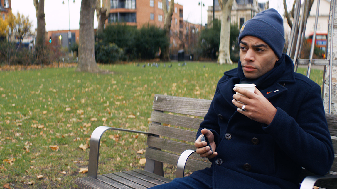 Ben Bailey Smith sitting on a bench